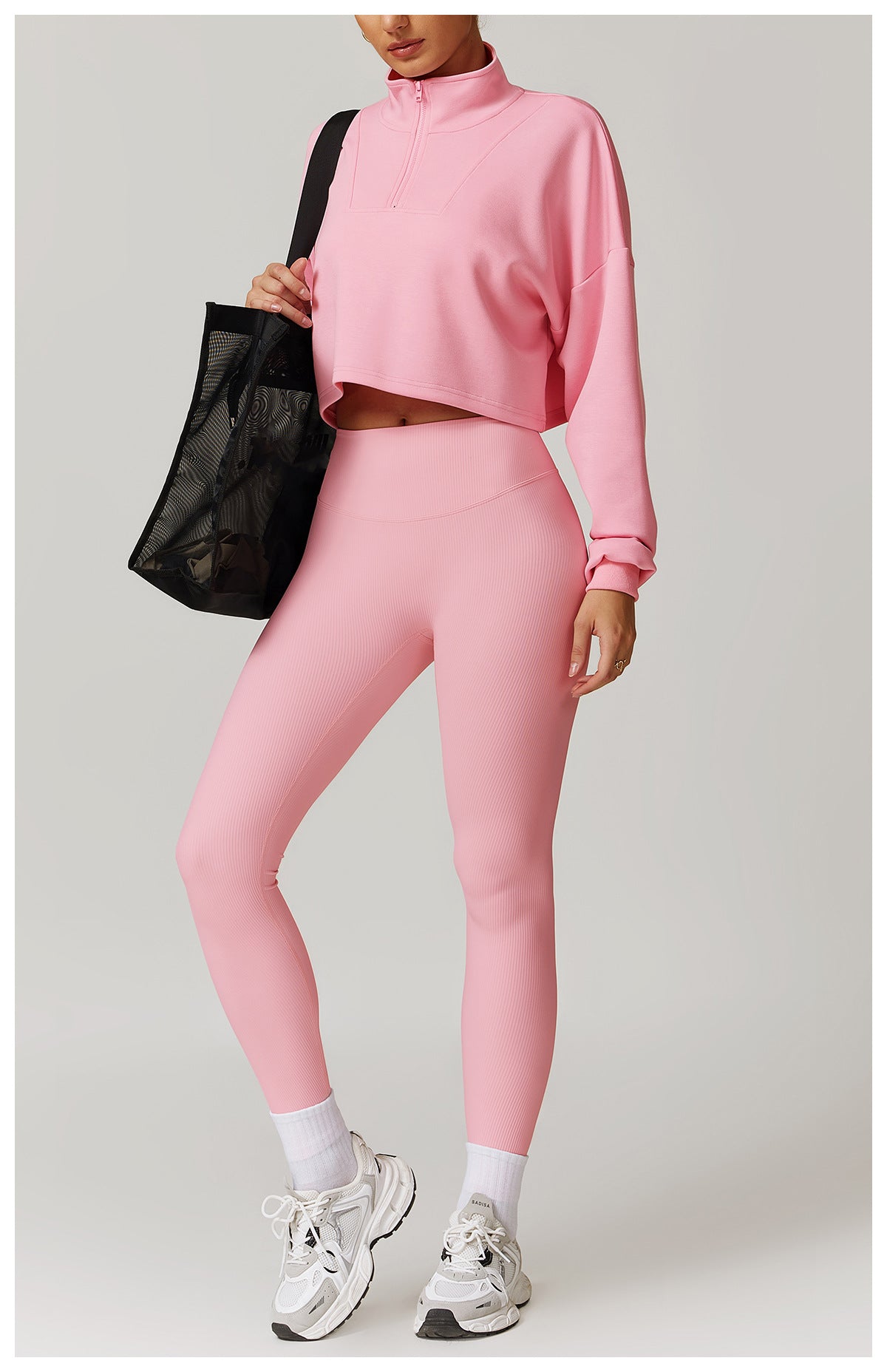 Pink cropped turtleneck and leggings set with white sneakers, perfect for Winter Wild fashion