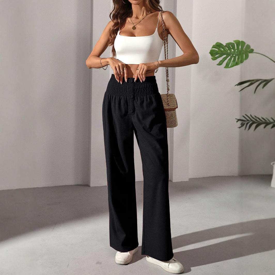 Woman wearing casual elegant French trousers and white cami crop top