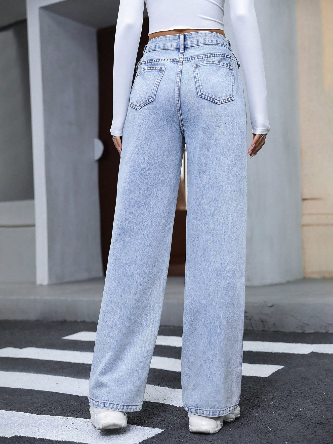 Light blue high-waisted wide-leg denim trousers with distressed wash for fashionable langry style