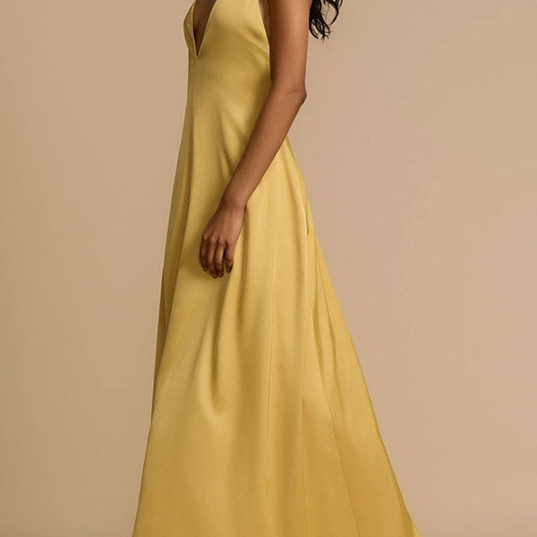 Elegant mustard-yellow satin maxi dress showcasing luxury fashion and sophisticated style