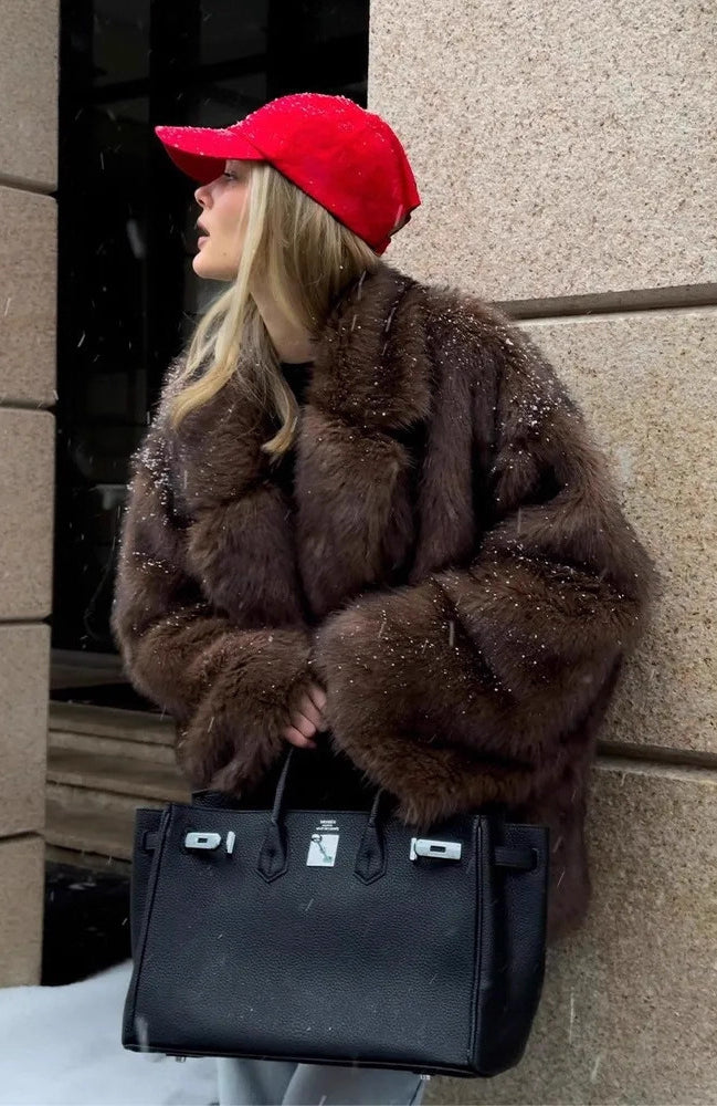 Fashionable Langry faux fur coat with black leather Hermès Birkin handbag