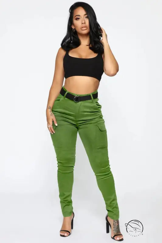Woman in black crop top and casual skinny stretch belt sports pants