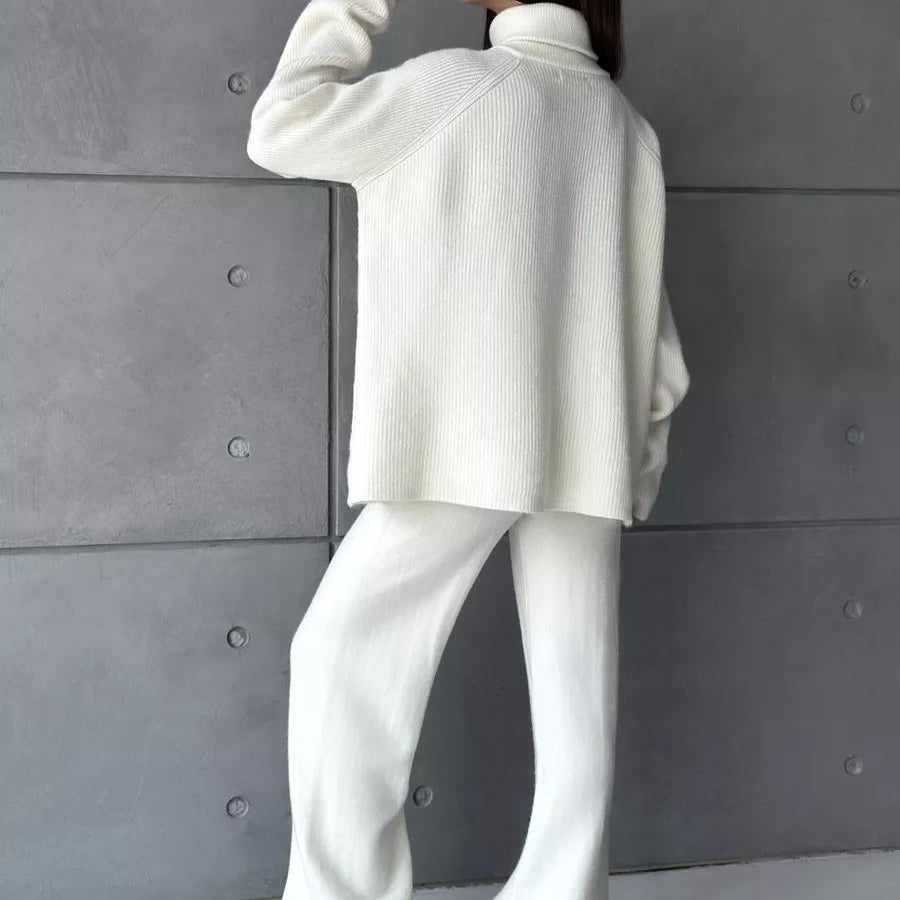 Woman in white knitwear outfit showcasing the High Collar Zipper Knitted Sweater Suit fashion