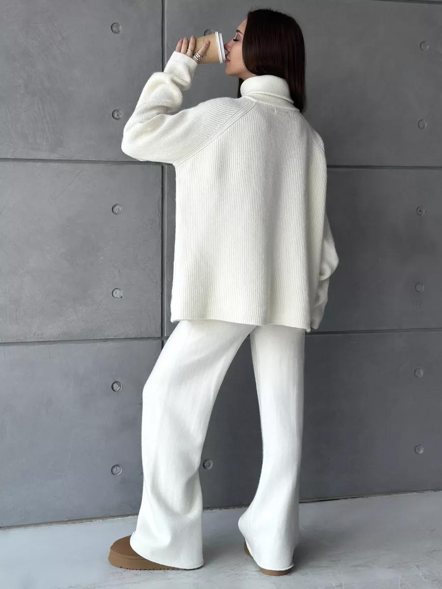 Woman in white knitwear outfit showcasing the High Collar Zipper Knitted Sweater Suit fashion