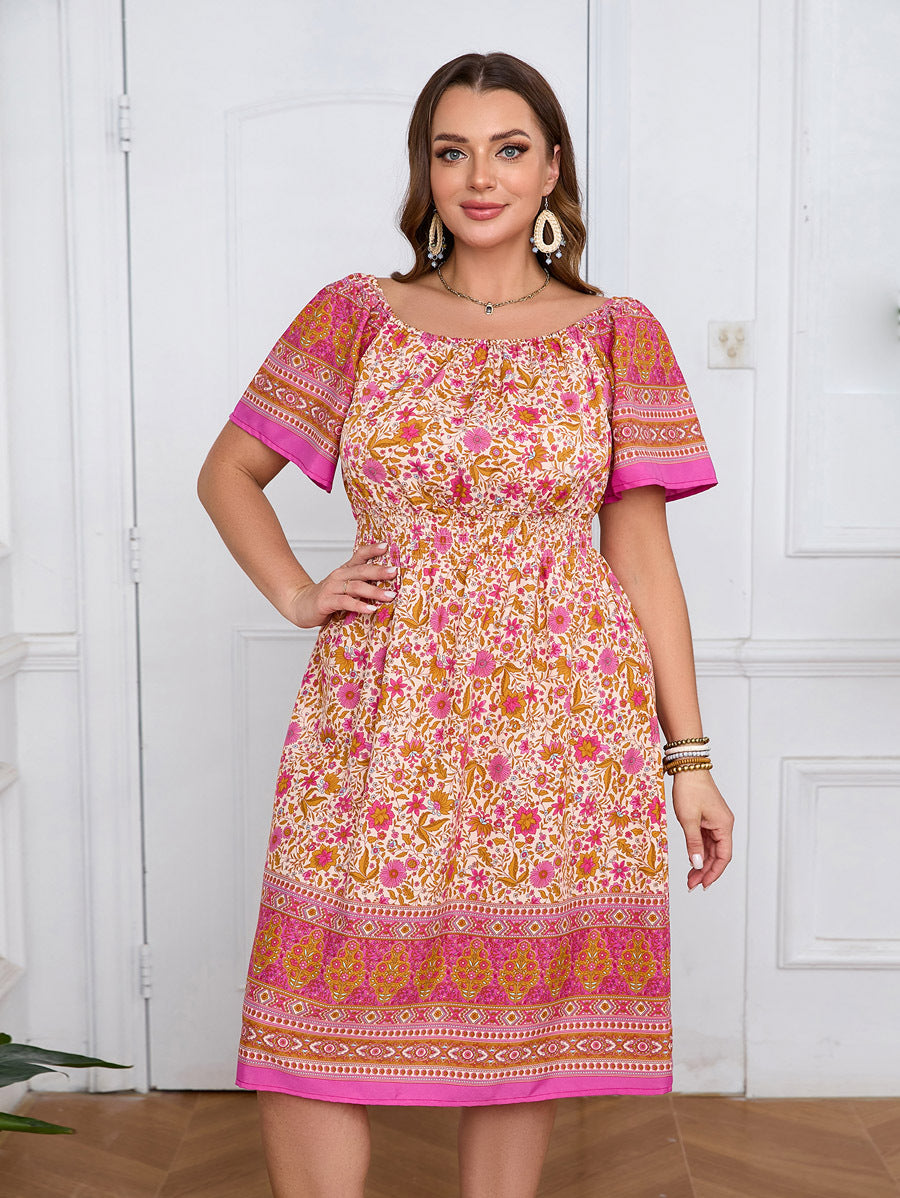 Plus-size elegant bohemian dress with colorful floral border print in shades of pink and orange