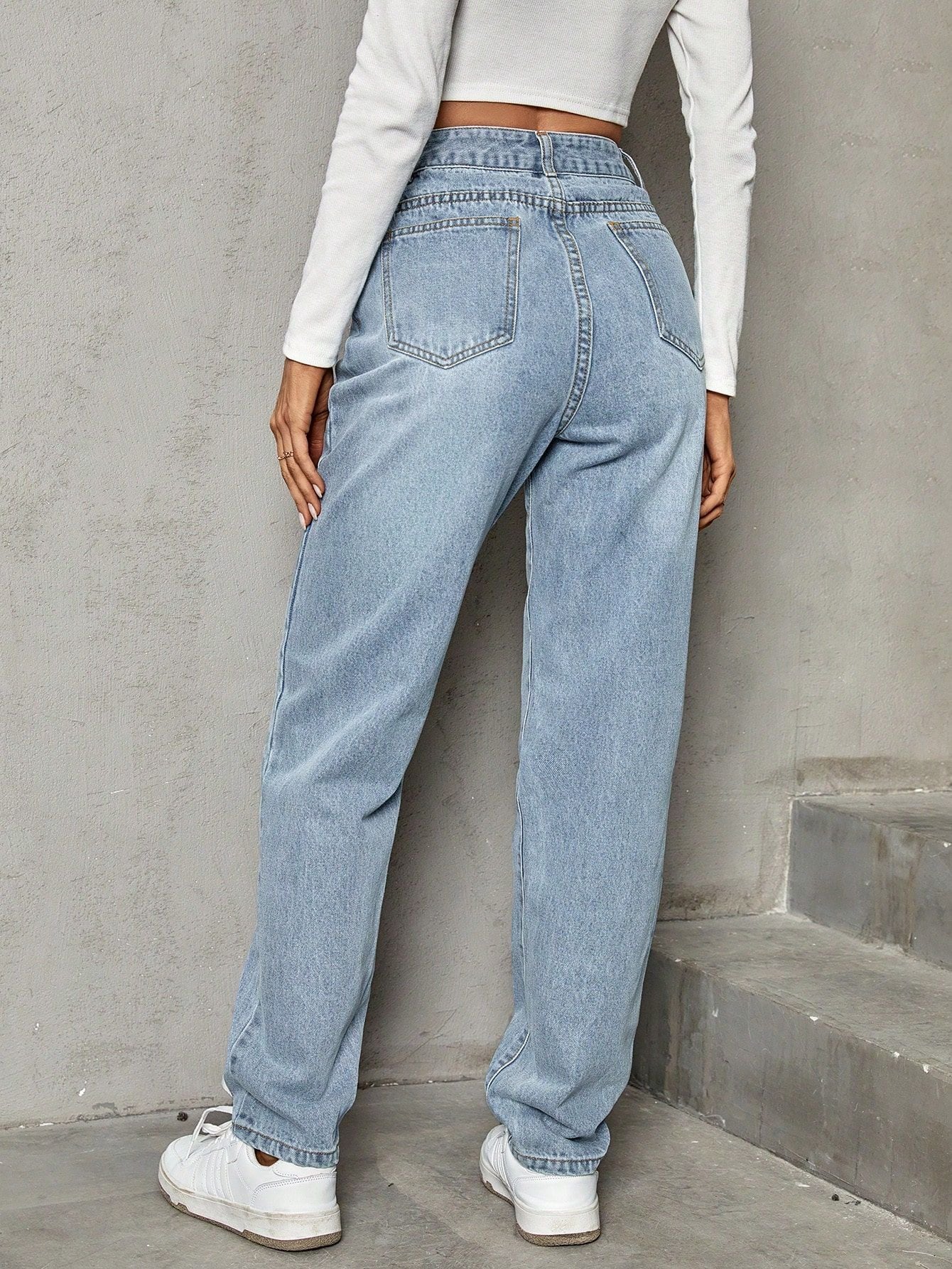 Light wash blue high-waisted baggy jeans with straight leg, elastic slimming denim trousers