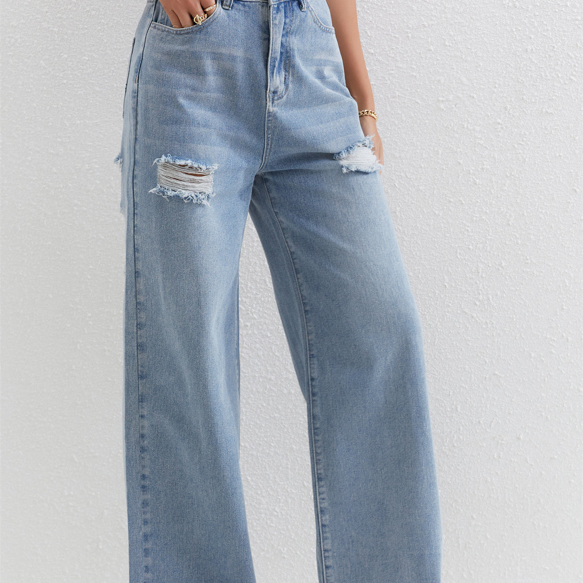 Light blue distressed wide-leg jeans with ripped details, perfect for stylish fashion outfits