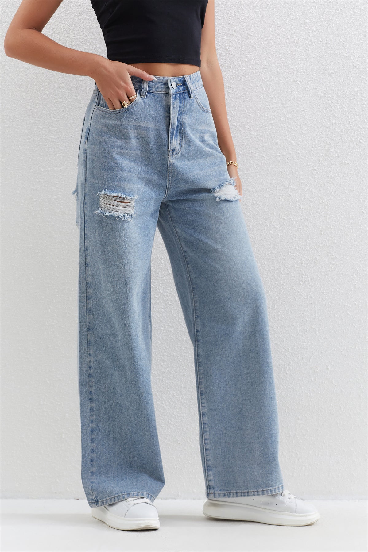 Light blue distressed wide-leg jeans with ripped details, perfect for stylish fashion outfits