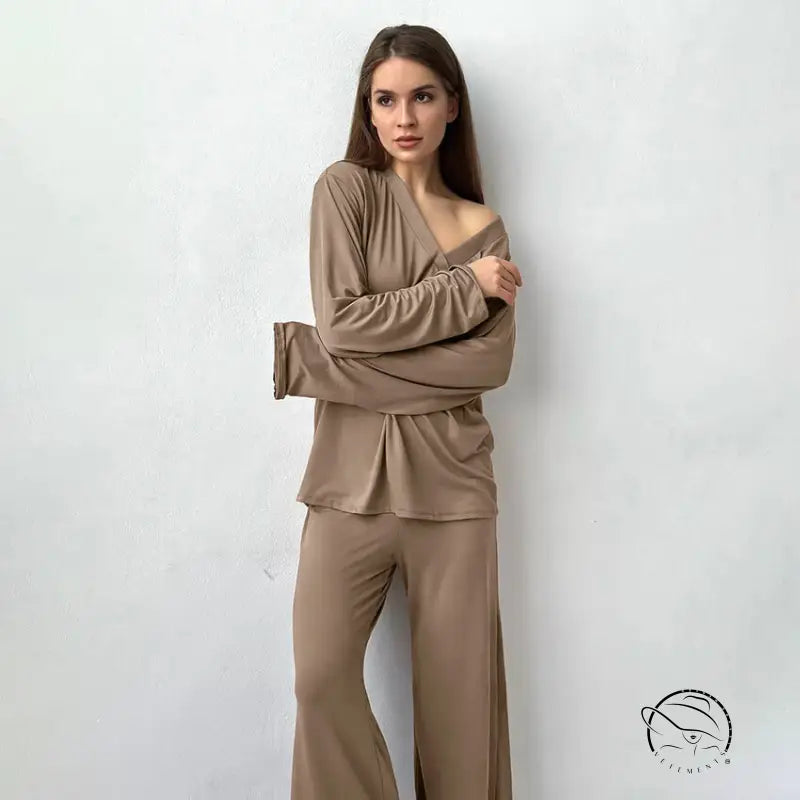 Woman modeling comfortable knitted pajamas in taupe off-shoulder top and pants