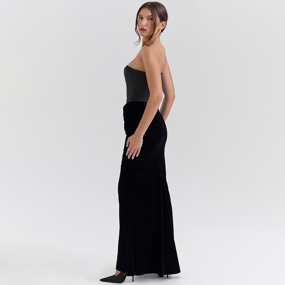 Woman in a strapless top and black velvet skirt showcasing an elegant maxi dress fashion