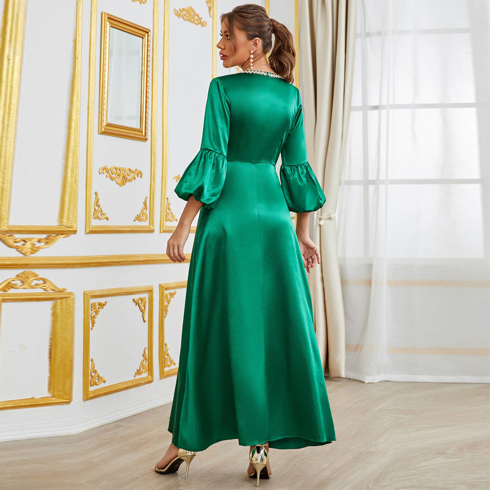 Green langry fashion maxi dress with bell sleeves, gold trim, and heels