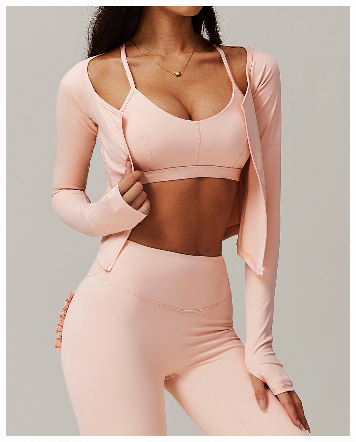 Pink workout set featuring a sports bra, leggings, and zip-up jacket for trendy fitness fashion