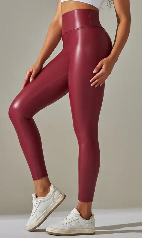 Burgundy high waist faux leather leggings with white sneakers