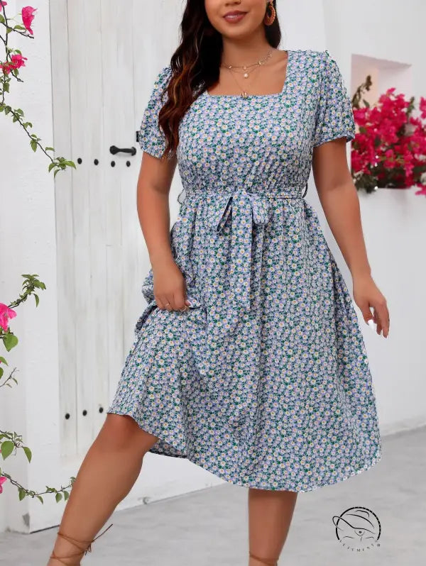 Woman modeling floral summer dress in blue and white print