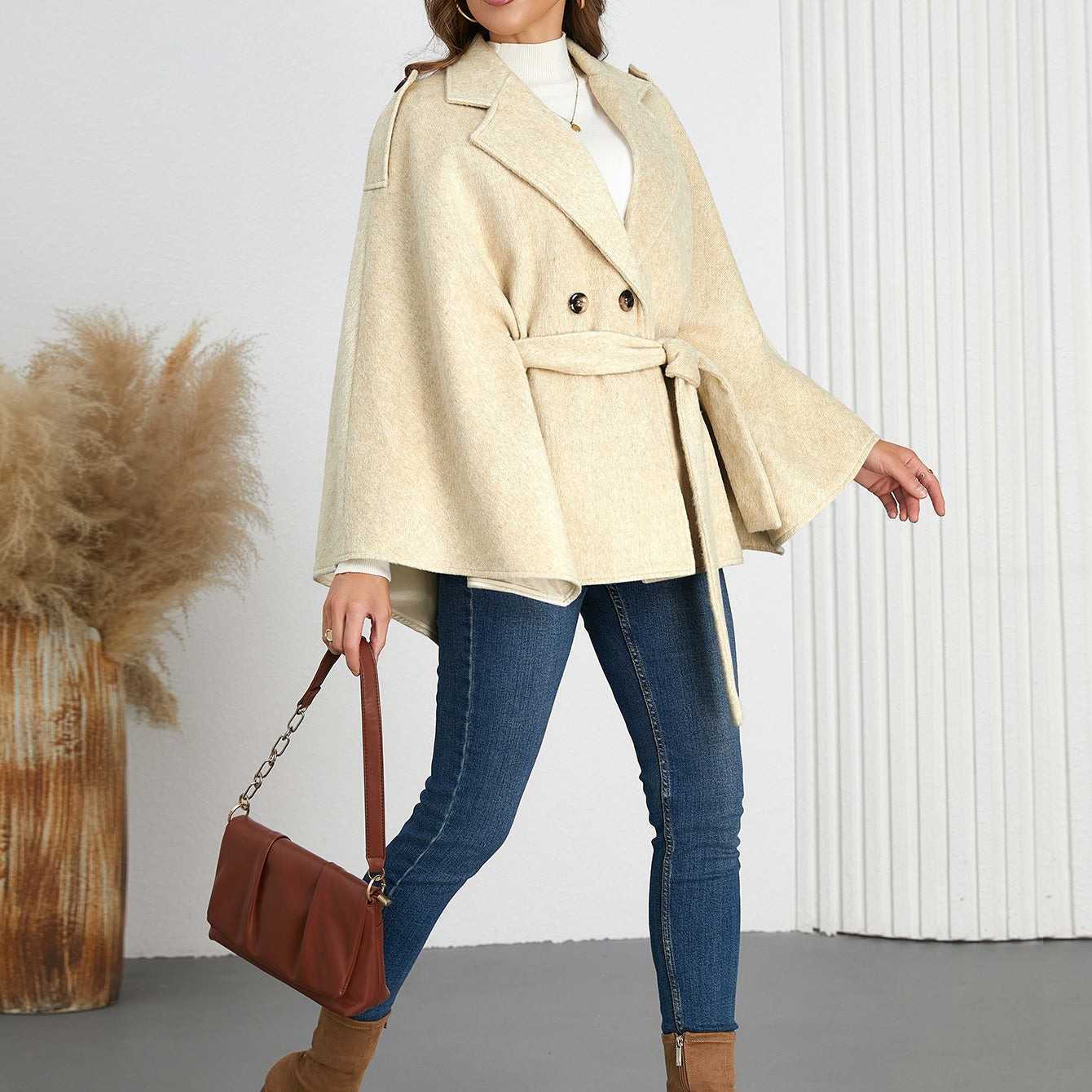 Woman in a beige cape coat and jeans showcasing Winter Woolen Coat fashion ملابس