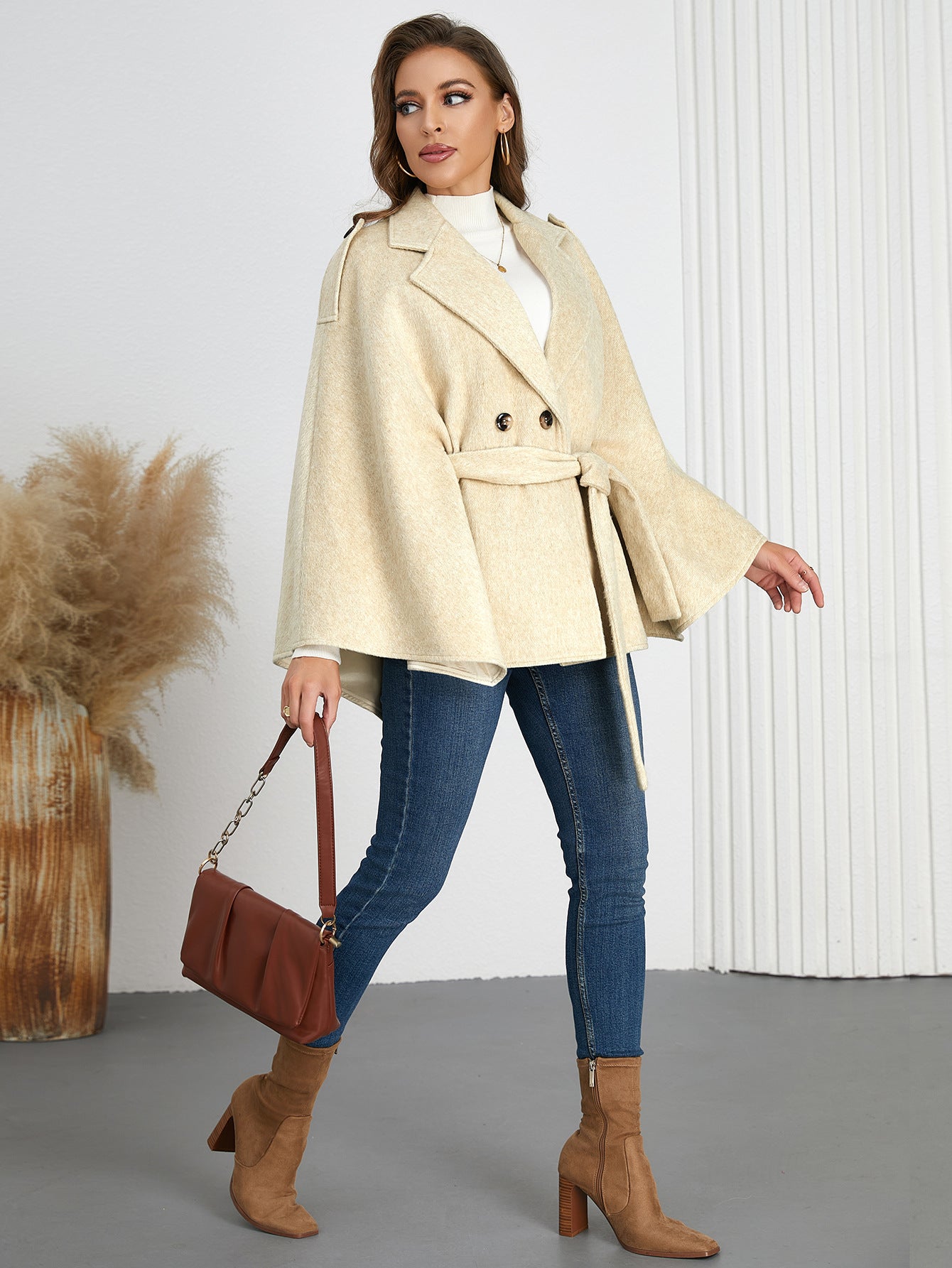 Woman in a beige cape coat and jeans showcasing Winter Woolen Coat fashion ملابس