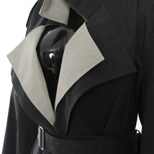 Casual langry fashion trench coat in black with white accents and belt