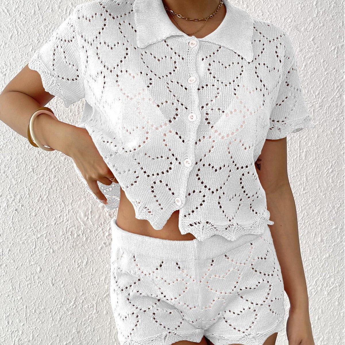 White knitted heart-patterned shorts and collared shirt set for stylish beach fashion