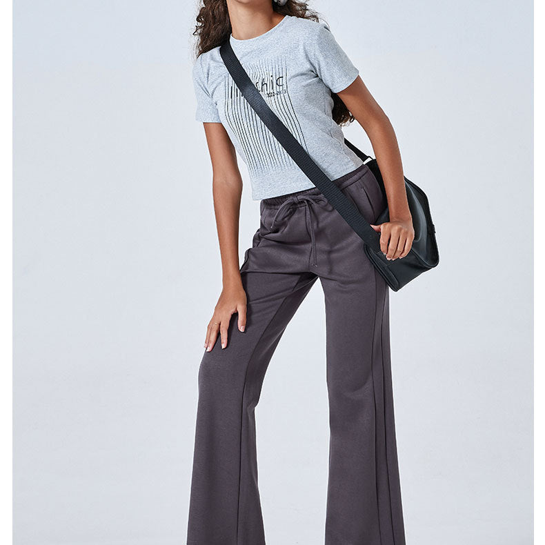 Person in a white striped t-shirt and gray wide-leg Summer Air Layer sports trousers