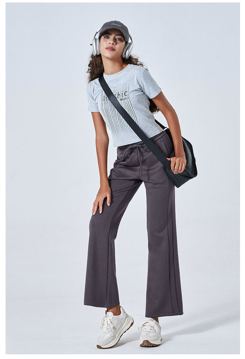 Person in a white striped t-shirt and gray wide-leg Summer Air Layer sports trousers