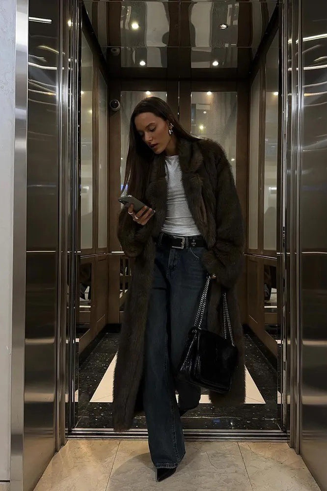 Brown vintage faux fur jacket with white shirt, blue jeans, black heels, silver bag