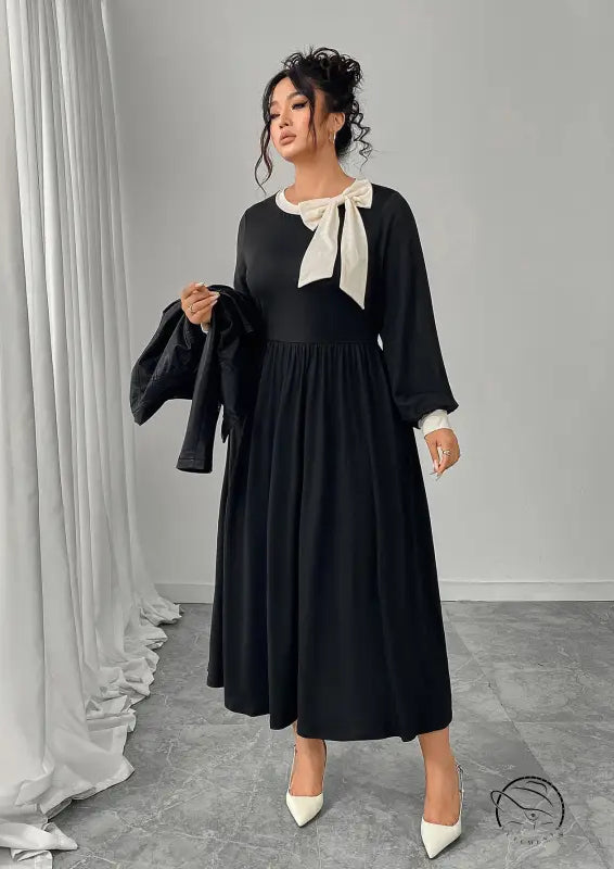 Winter retro slim black dress with long sleeves, white bow, and pleated skirt