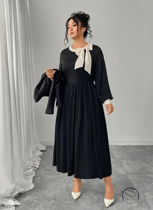 Winter retro slim black dress with long sleeves, white bow, and pleated skirt