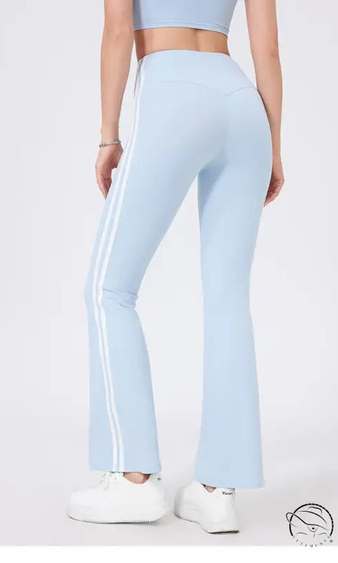 Light blue high waist yoga pants with white stripes and peach hip raise