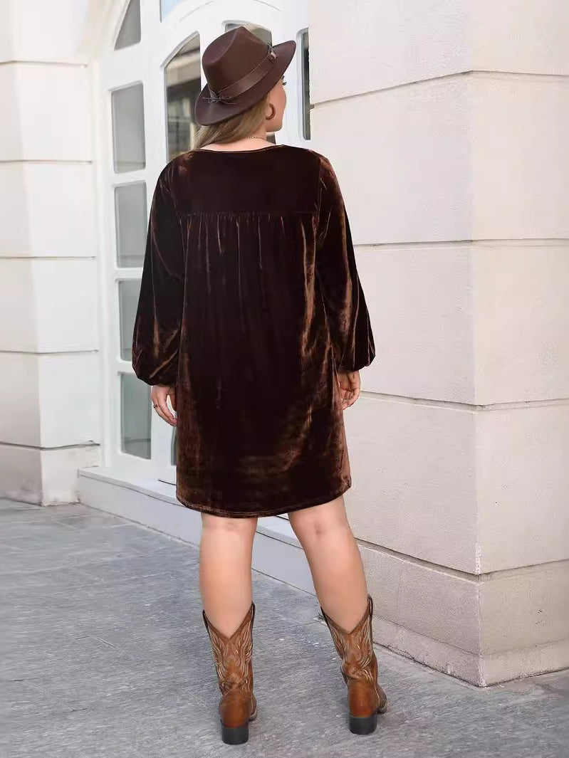 Woman wearing dark brown velvet loose slimming casual dress with long cuffed sleeves