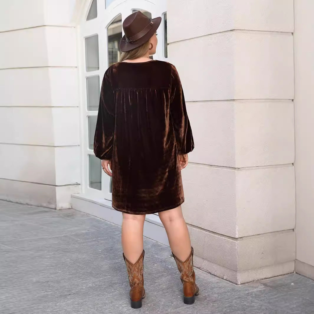 Woman wearing dark brown velvet loose slimming casual dress with long cuffed sleeves
