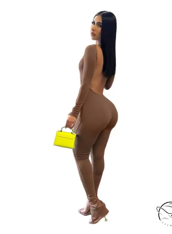 Woman in elegant backless slit jumpsuit with yellow purse