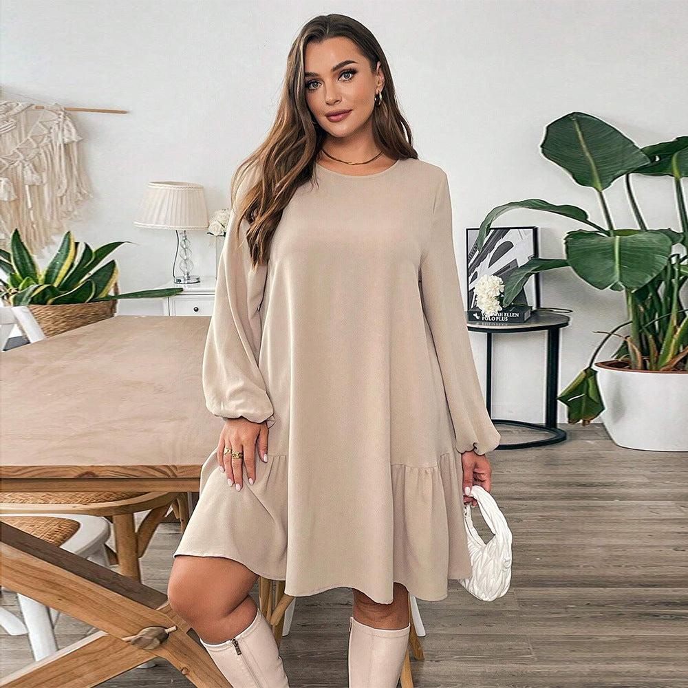 Woman wearing a beige long-sleeved midi dress with tiered ruffle hem for fashion