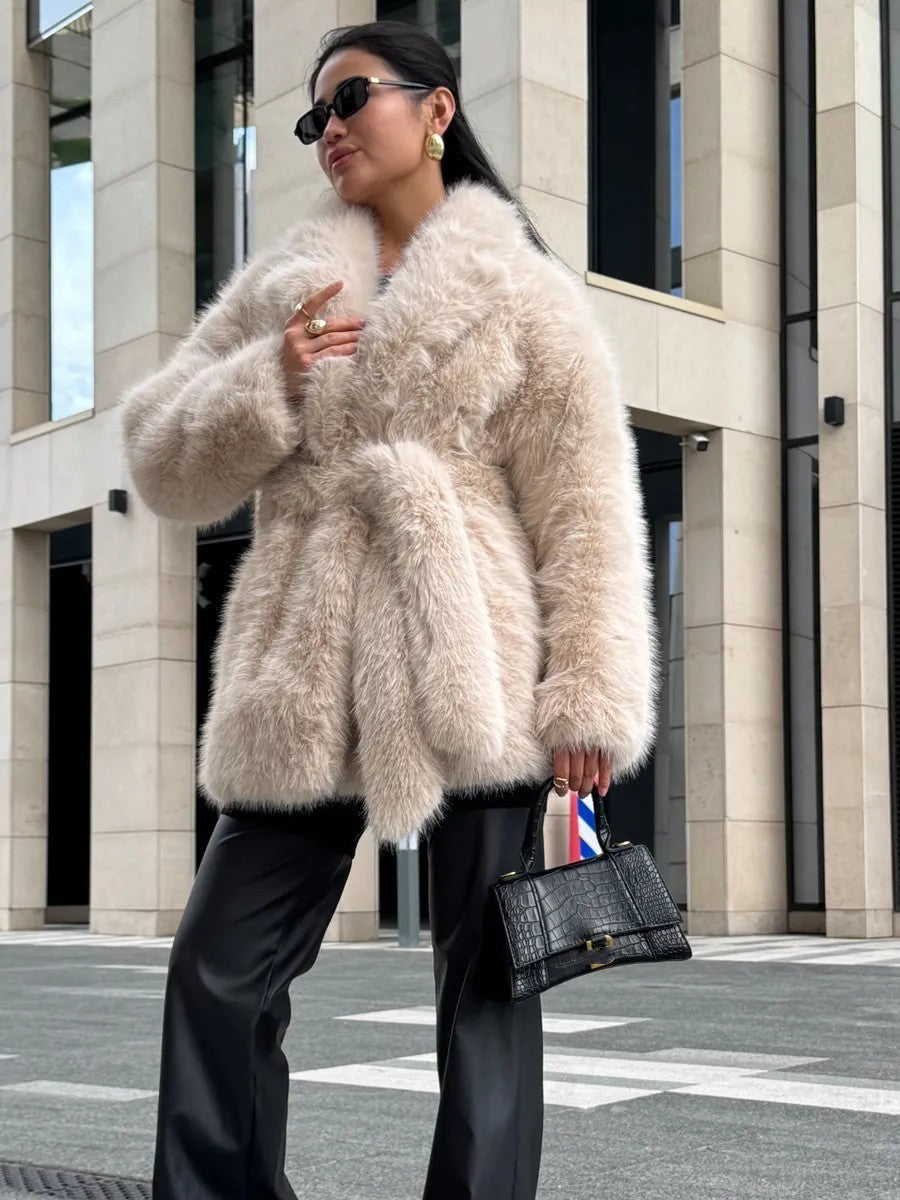 Beige fluffy faux fur coat with black sunglasses and handbag