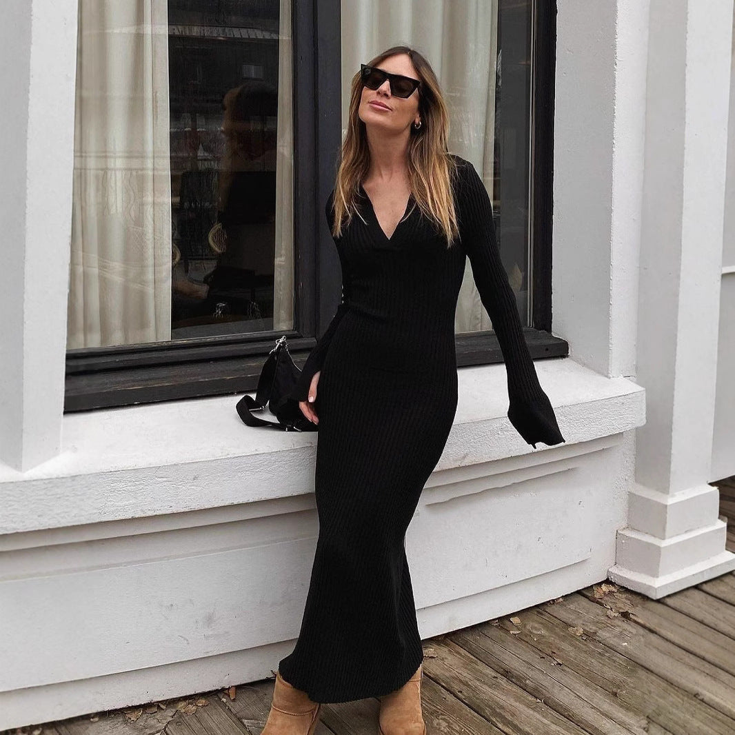 Woman in a stylish black long-sleeved maxi dress showcasing elegant fashion