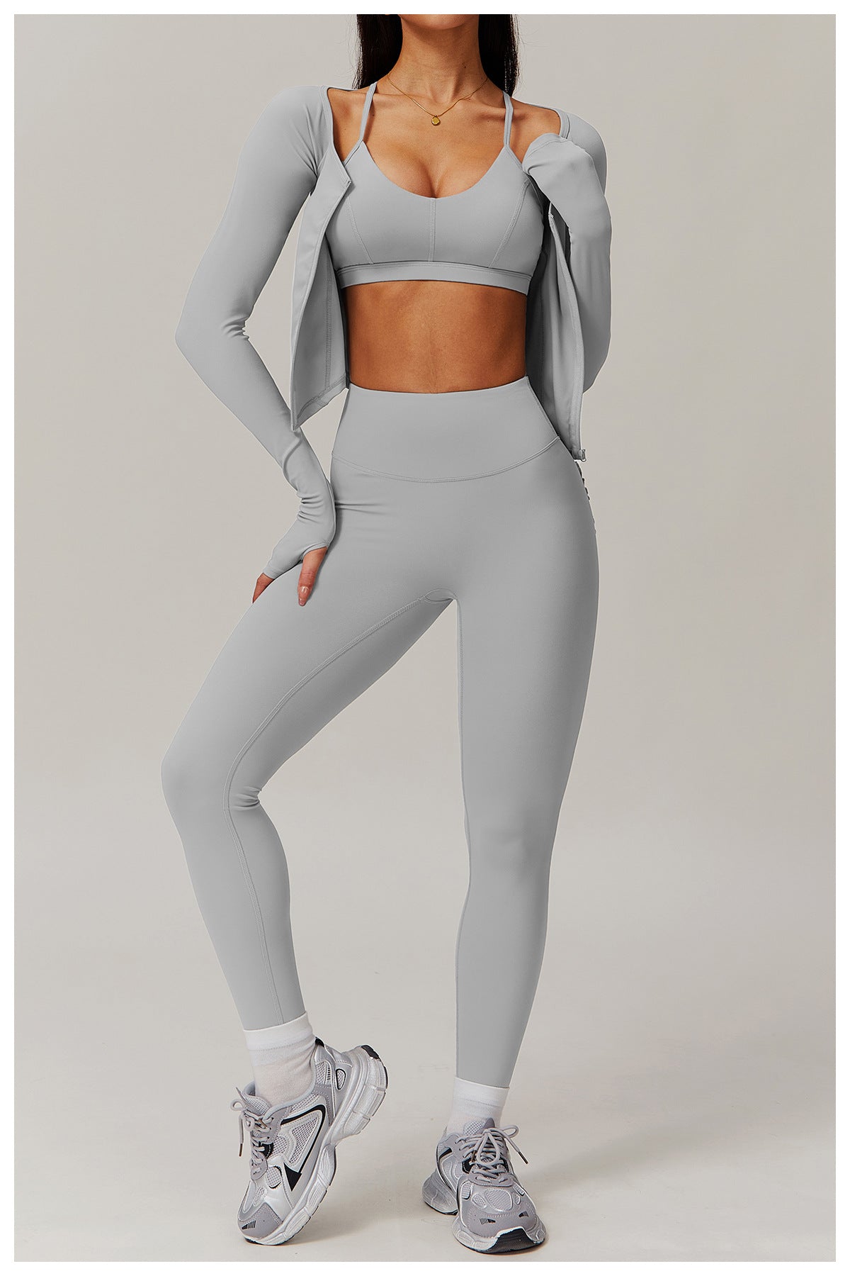 Light grey workout set including sports bra, leggings, jacket, and white sneakers for yoga fashion