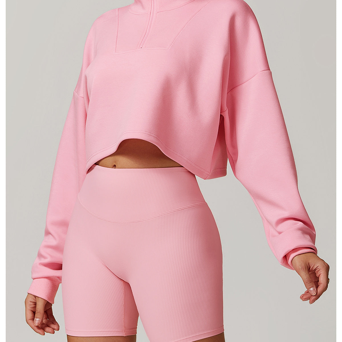 Pink cropped sweatshirt and biker shorts set by Langry for stylish winter sports fashion