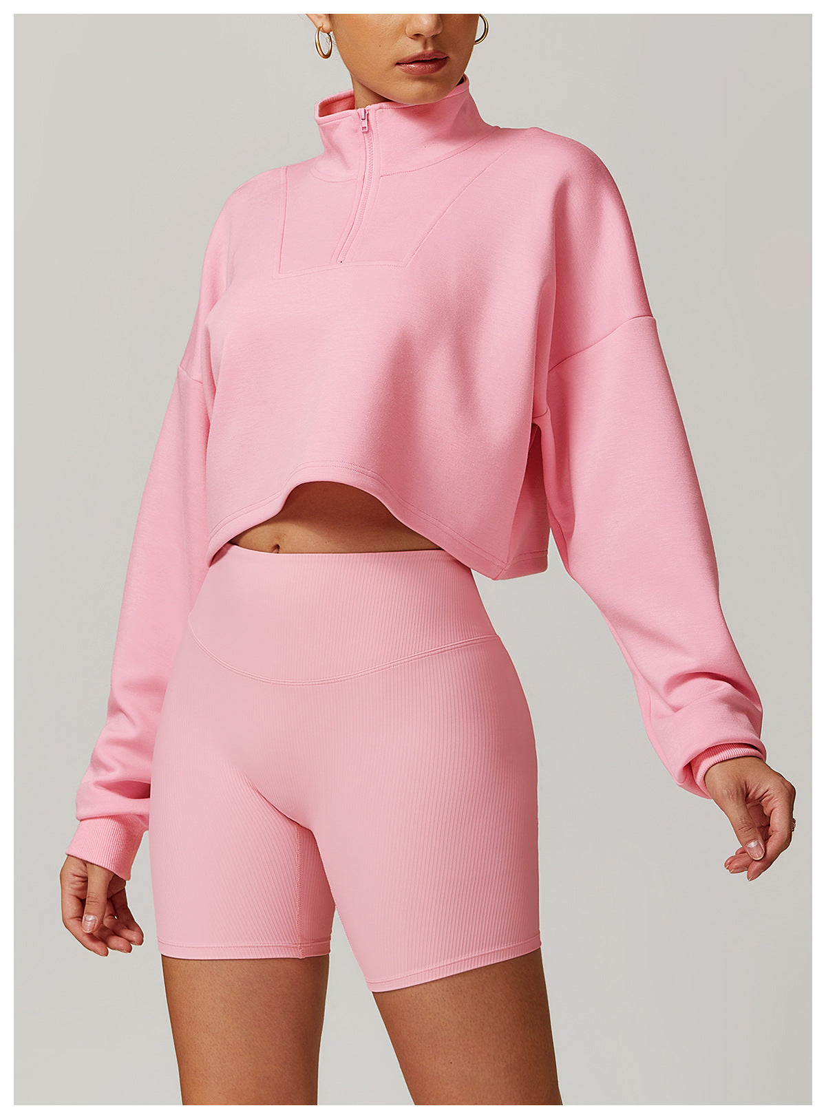 Pink cropped sweatshirt and biker shorts set by Langry for stylish winter sports fashion