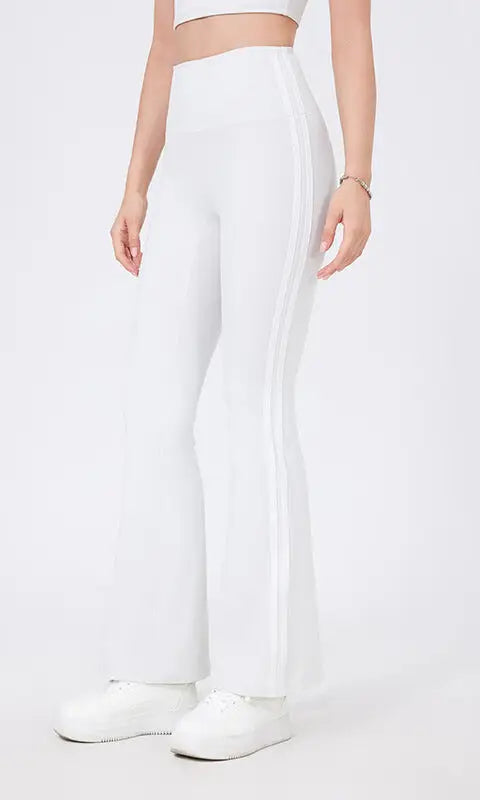 White high waist yoga pants with flared legs, peach hip raise design and side stripes