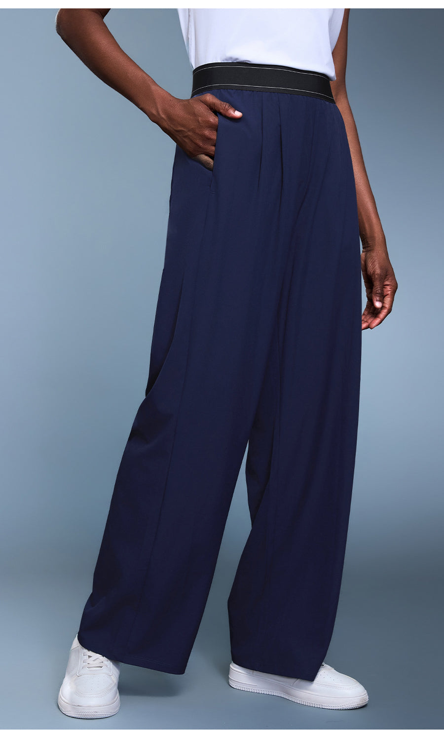 Navy blue langry fashion wide-leg trousers with black waistband and white sneakers