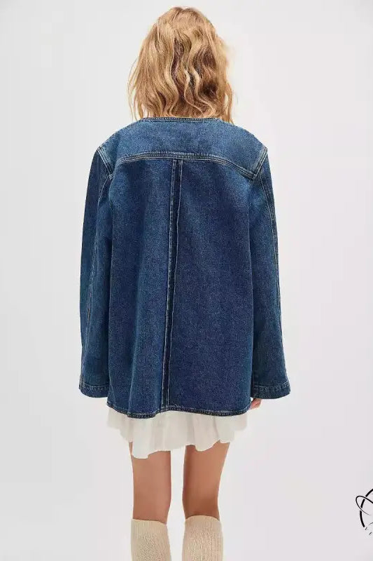 Woman in casual fashionable cowboy coat, denim jacket over ruffled dress