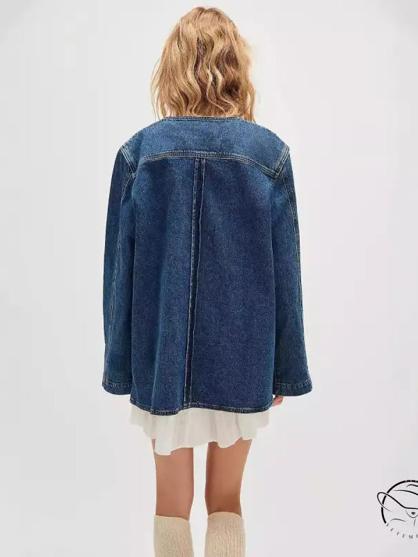 Woman in casual fashionable cowboy coat, denim jacket over ruffled dress