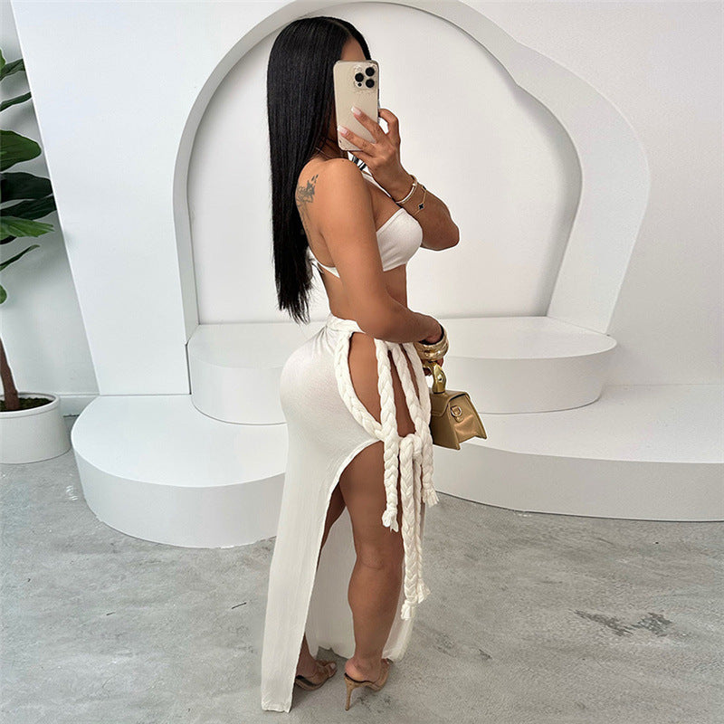 Elegant woman in white two-piece outfit showcasing Summer Backless Slit Stitching Strap dress fashion