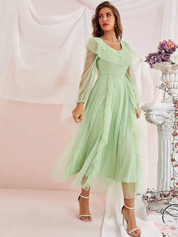Woman in gorgeous high-waist A-line voile dress with sheer sleeves and ruffles