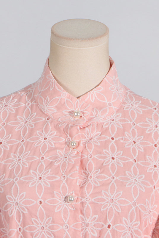 Pink eyelet blouse with stand collar and ruffled bell sleeves for elegant summer fashion
