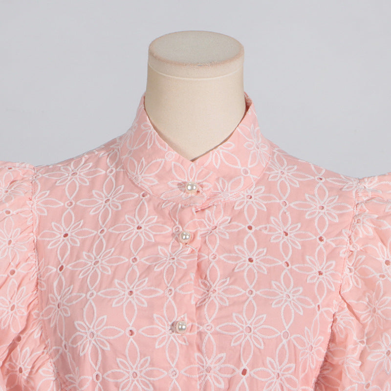 Pink eyelet blouse with stand collar and ruffled bell sleeves for elegant summer fashion