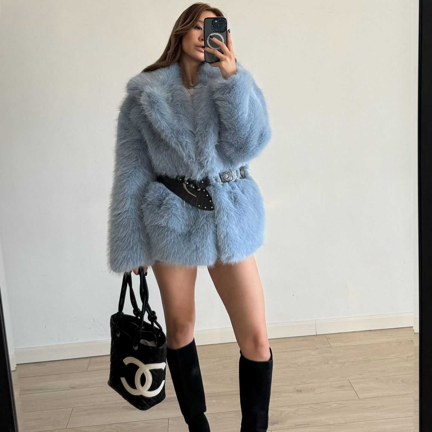 Light blue faux fur coat with black belt and Chanel bag