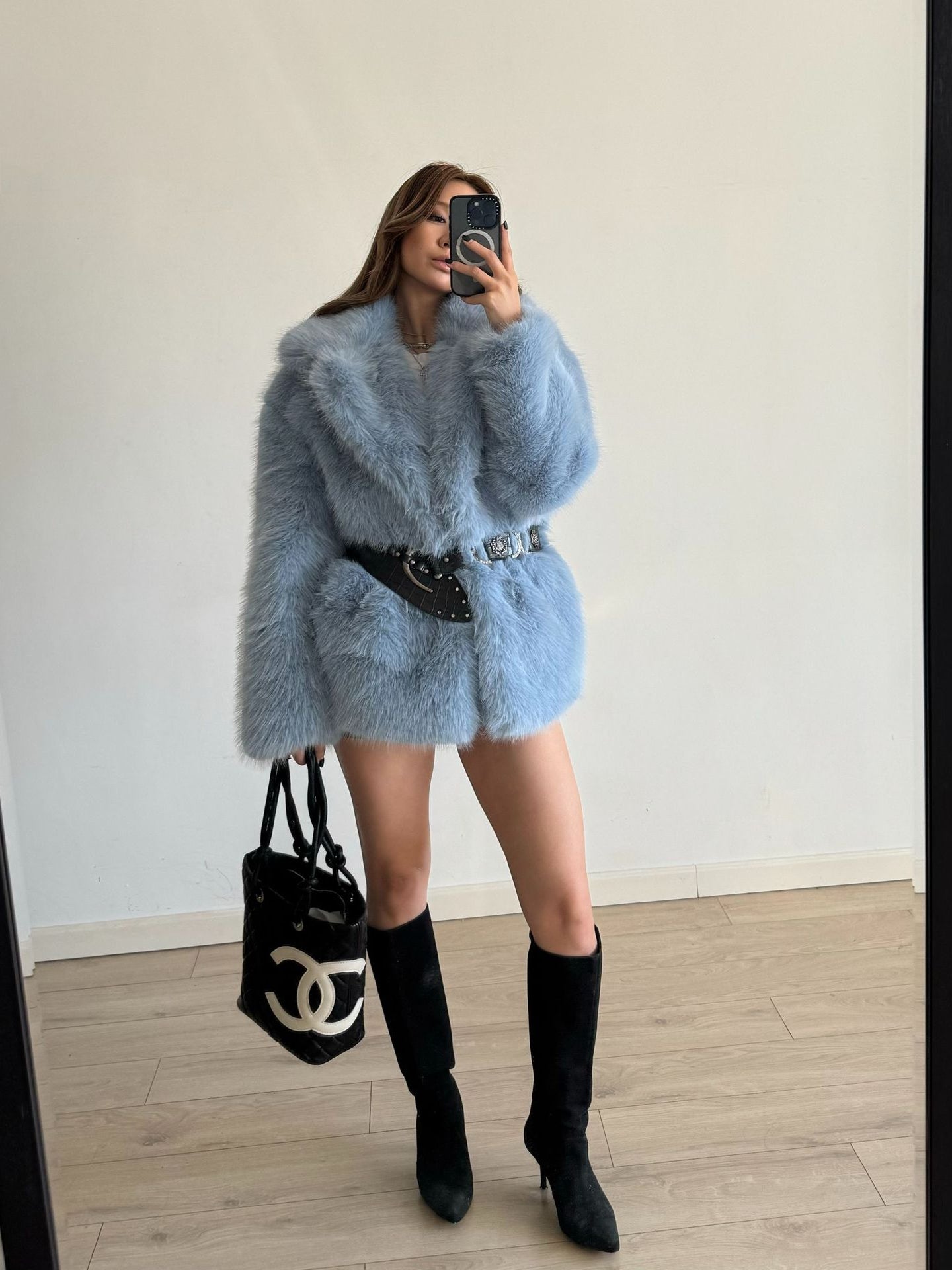 Light blue faux fur coat with black belt and Chanel bag