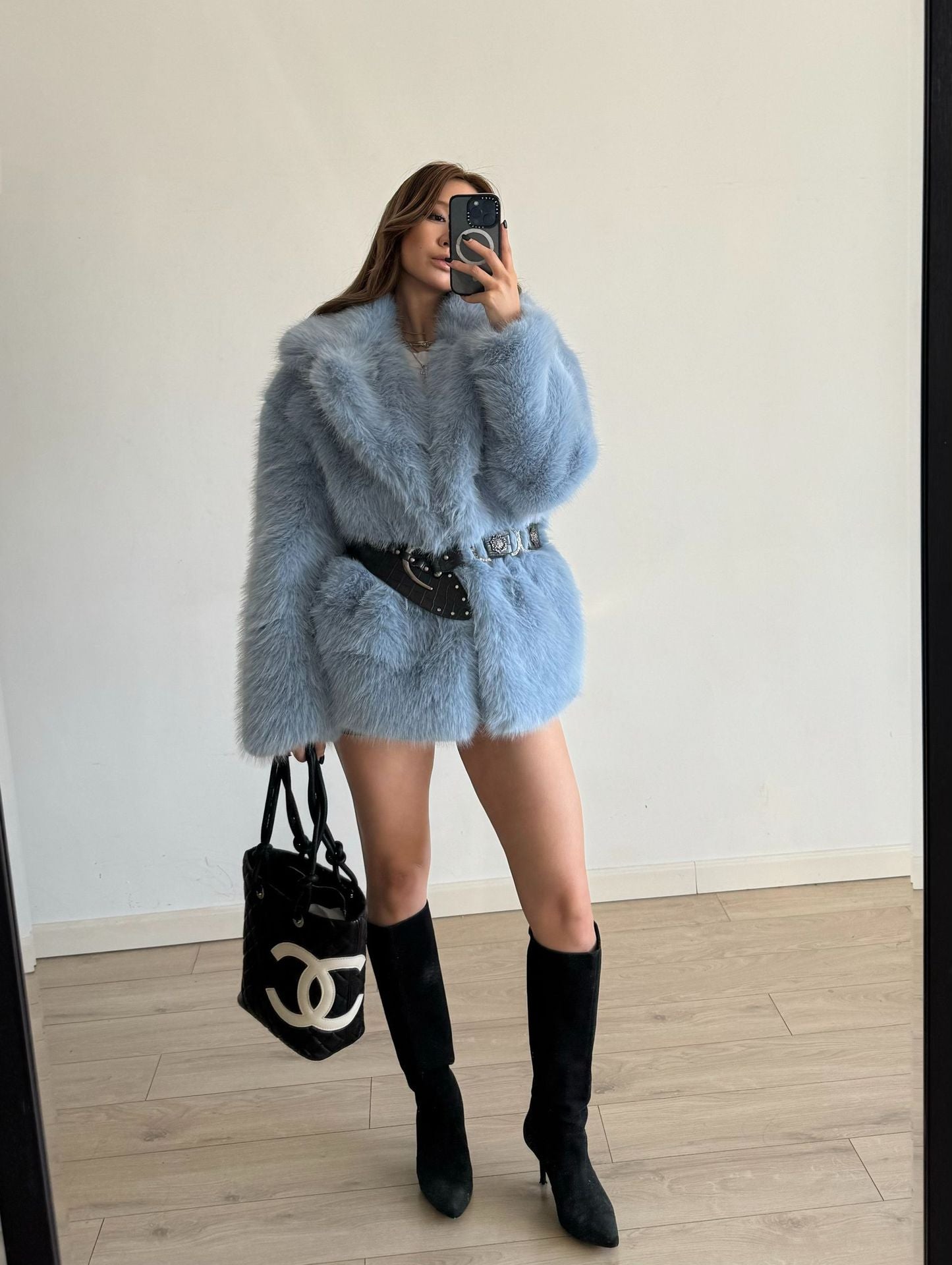 Light blue faux fur coat with black belt and Chanel bag