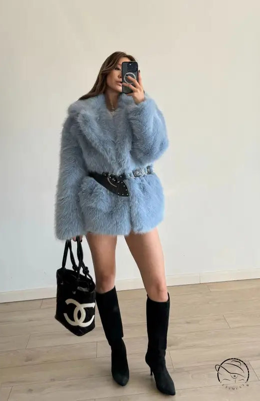 Light blue fluffy faux fur coat with black belt and Chanel bag