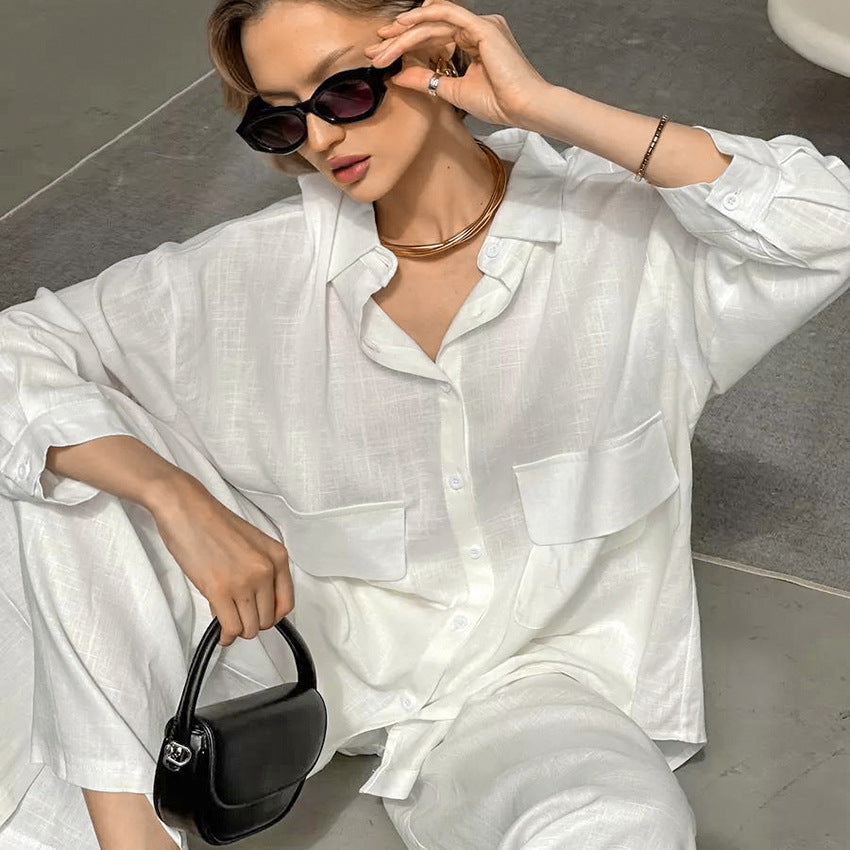 Woman in white linen outfit with sunglasses and black handbag, ideal for cotton cardigan loose pajamas